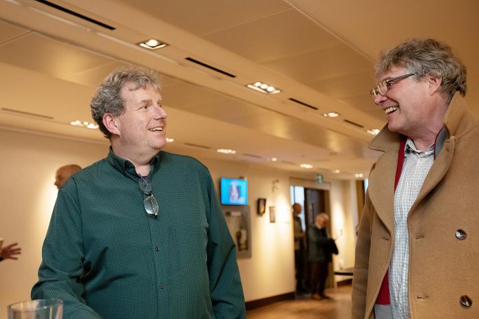 Gavin Muir, a potential candidate for Northcrest Ward in the City of Peterborough, speaks with potential mayoral candidate Michael Eamon in the lobby at Market Hall Performing Arts Centre in downtown Peterborough during the "So, You Want to Run for Council - Candidate 101 Information Session" on March 31, 2026. (Photo: Jordan Lyall / kawarthaNOW)