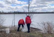 Two of the 35-plus volunteers who participated in an Earth Day clean-up of Rogers Cove park in Peterborough on April 19, 2026, picking up litter along the Little Lake waterfront and in the park. The clean-up was organized by Becca Durbin, owner of Salix Environmental Consulting, in partnership with Clean Up Peterborough and the City of Peterborough. (Photo: Bethan Bates / kawarthaNOW)