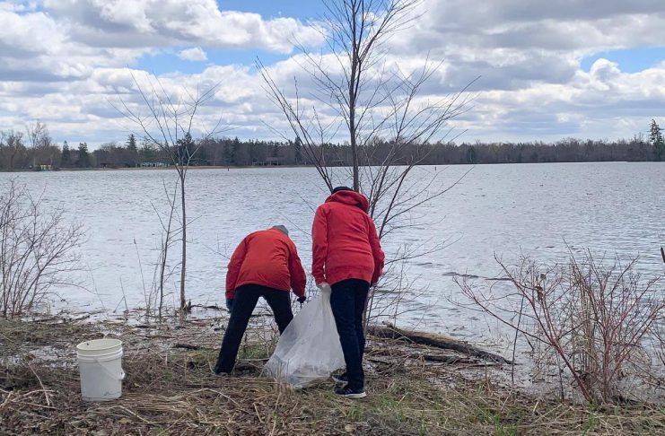 Two of the 35-plus volunteers who participated in an Earth Day clean-up of Rogers Cove park in Peterborough on April 19, 2026, picking up litter along the Little Lake waterfront and in the park. The clean-up was organized by Becca Durbin, owner of Salix Environmental Consulting, in partnership with Clean Up Peterborough and the City of Peterborough. (Photo: Bethan Bates / kawarthaNOW)