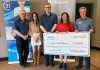 At its meeting on April 27, 2026, the Rotary Club of Peterborough presents a $12,000 cheque to Easter Seals Ontario, representing a portion of the $51,286.35 raised at the 40th annual Carl Oake Rotary Swim held on February 27. Pictured from left to right are Rotarian Ken Seim, Century 21 United owner Vanessa Oake Hogan, Baker Tilly managing partner Jeff Taylor, Easter Seals Ontario development officer Andrea Peterson, and Rotary Club of Peterborough president Tony Grady. (Photo courtesy of Rotary Club of Peterborough)