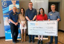 At its meeting on April 27, 2026, the Rotary Club of Peterborough presents a $12,000 cheque to Easter Seals Ontario, representing a portion of the $51,286.35 raised at the 40th annual Carl Oake Rotary Swim held on February 27. Pictured from left to right are Rotarian Ken Seim, Century 21 United owner Vanessa Oake Hogan, Baker Tilly managing partner Jeff Taylor, Easter Seals Ontario development officer Andrea Peterson, and Rotary Club of Peterborough president Tony Grady. (Photo courtesy of Rotary Club of Peterborough)