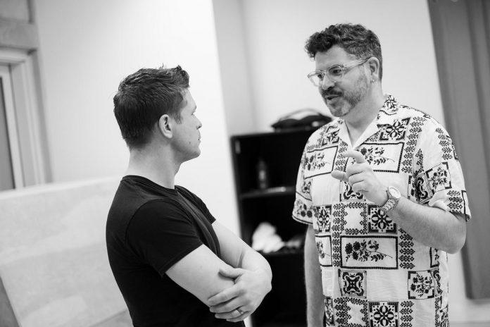 During a rehearsal of "You're A Good Man, Charlie Brown," Capitol Theatre artistic director Rob Kempson (right) speaks with Kyle Golemba, who plays the role of the ivory-tinkling Schroeder. Kempson is the director and choreographer of the family-friendly musical based on the characters created by Charles M. Schulz, which runs for 19 performances from May 15 to 31, 2026 at the historic venue in downtown Port Hope. (Photo: Sam Moffatt)