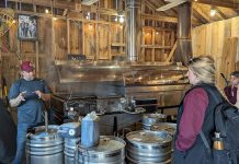 Red Mill Maple Syrup co-owner Sebastien Poulin (left) leads a tour about maple syrup production at the Millbrook producer's sugar shack. He and his wife Julie Vallieres, who were both raised in a region of Quebec well-known for maple syrup, have been producing maple syrup at their 10-acre property since 2011 and launched the Red Mill Maple Syrup brand in 2017. The business is a member of Kawartha Choice FarmFresh to promote their products to consumers and is interested in participating in the Kawartha Local Food Wholesale program to reach more wholesale buyers. (Photo courtesy of Red Mill Maple Syrup)