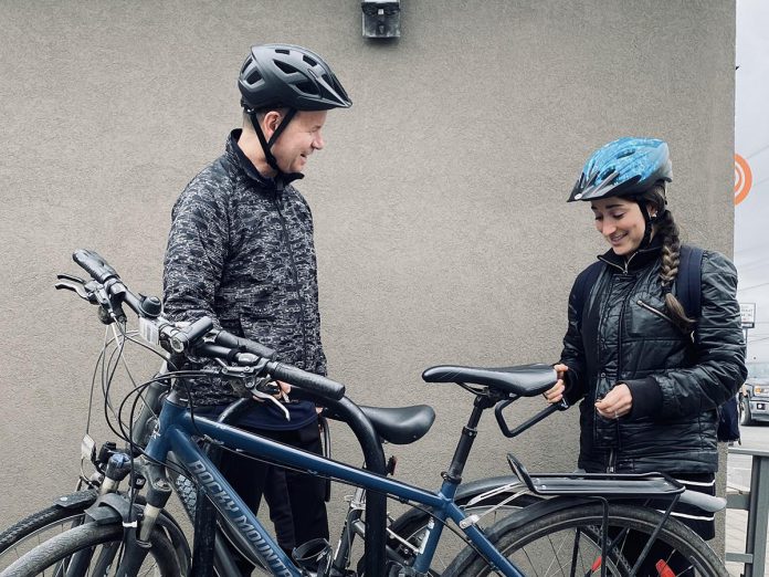 While Dr. Joe Hoja (left) of Peterborough Optimetric has spent decades cycling through Peterborough, commuting by bike is a newer experience for his colleague Dr. Bella Sudik (right). Now sharing a similar ride to work, the two have bonded over their love of cycling and rarely miss a chance to swap biking tips. (Photo: Rebekkah Hyams / GreenUP)