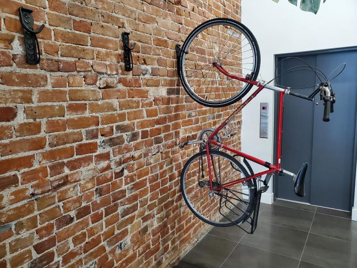 Sometimes the smallest changes can have the biggest impact. At downtown Peterborough shared office space Unicity, a few simple bike hooks transformed an unused area into secure bicycle parking, making it easier for employees to choose active transportation. Small investments like these not only encourage people to rethink their commute but also show staff their efforts to reduce their carbon footprint are valued and supported. (Photo: Brett Throop / GreenUP)