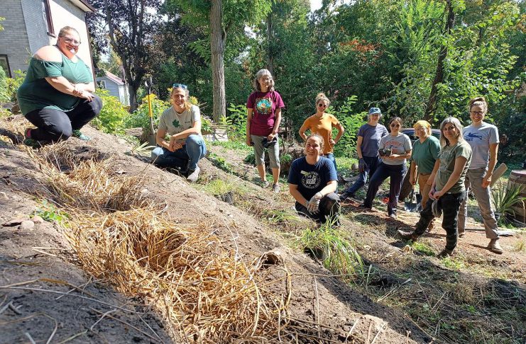 GreenUP volunteers pose for a photo to showcase the end product of a landscape contouring workshop in fall 2025 as part of GreenUP's Restoration Wednesdays Volunteer Stewardship event series. After creating swales and berms, it's beneficial to mulch the berms to protect the exposed soil from the sun and wind. Woodchips, straw, dried leaves, or any other seedless light organic matter will do the trick. (Photo: Christina Balint / GreenUP)
