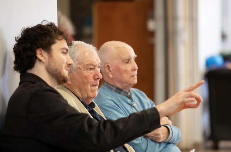 Retired Ontario Superior Court Justice and poet James Clarke (middle) watching a rehearsal on April 28, 2026 of Trent Valley Archives Theatre's "The Kid from Simcoe Street," based on his 2012 memoir of the same title, along with his grandson and script consultant David Francis Clarke and his old friend Murray Byrne, who he was recently reunited with after 73 years and who makes a cameo in the play, which is being staged at Market Hall Performing Arts Centre for four performances from June 4 to 7, 2026. (Photo: Jordan Lyall Photography)