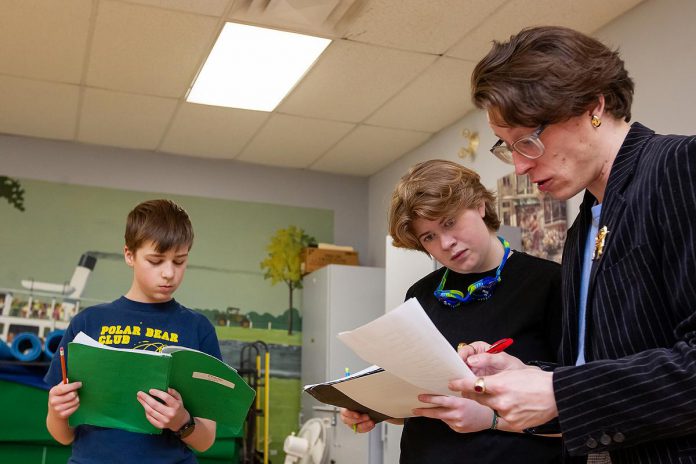 "The Kid from Simcoe Street" actor Zoe Shufelt and director Drew Mills consult over a script while Charlie Harris reads his own during a rehearsal for the Trent Valley Archives Theatre production. Shufelt and Harris will both be playing the role of retired Ontario Superior Court Justice and poet James Clarke at different ages during the fundraiser production for Trent Valley Archives. (Photo: Jordan Lyall Photography)