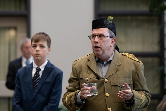 Ron Jewer (right) as Sam Clarke, father of young Jimmy Clarke (left), played by Charlie Harris, during a special preview dress rehearsal of Trent Valley Archives Theatre's "The Kid from Simcoe Street" at Canterbury Gardens in Peterborough on May 28, 2026. In this scene, Sam announces he has enlisted to fight in the Second World War — a decision that will have far-reaching consequences for his family. Jim Mills (in the background) is the play's narrator. (Photo: Jordan Lyall Photography)