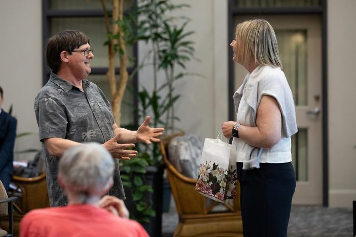 During a special preview dress rehearsal of Trent Valley Archives Theatre's "The Kid from Simcoe Street" at Canterbury Gardens in Peterborough on May 28, 2026, co-playwright Ed Schroeter presented a collection of four poetry books written by James Clarke, the main character of the play, to Canterbury Gardens manager of resident services Katie Zatorski for the retirement home's library. (Photo: Jordan Lyall Photography)