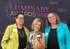 Dr. Jenny Ingram (middle) receiving the Legacy award, which honours a woman "whose career is defined by excellence, generosity, and community impact," at the Peterborough and Kawarthas Chamber of Commerce's second annual Luminary Awards celebration at Trent University's Champlain College on May 7, 2026. One of seven women who received awards, Dr. Ingram is a trailblazer in geriatric medicine and seniors' care and the founder of the Kawartha Centre, the site for international Alzheimer research trials, and recently released the documentary "No More Silent Battles." Also pictured are the inaugural Legacy award winner Jeannine Taylor of kawarthaNOW (left) and Julie Kellett of sponsor Darling Insurance. (Photo courtesy of Jeannine Taylor / kawarthaNOW)