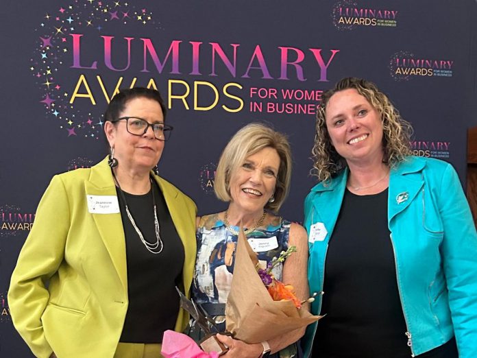Dr. Jenny Ingram (middle) receiving the Legacy award, which honours a woman "whose career is defined by excellence, generosity, and community impact," at the Peterborough and Kawarthas Chamber of Commerce's second annual Luminary Awards celebration at Trent University's Champlain College on May 7, 2026. One of seven women who received awards, Dr. Ingram is a trailblazer in geriatric medicine and seniors' care and the founder of the Kawartha Centre, the site for international Alzheimer research trials, and recently released the documentary "No More Silent Battles." Also pictured are the inaugural Legacy award winner Jeannine Taylor of kawarthaNOW (left) and Julie Kellett of sponsor Darling Insurance. (Photo courtesy of Jeannine Taylor / kawarthaNOW)