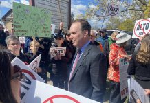 Federal transport minister Steven MacKinnon wades into a crowd of people protesting against the Alto high-speed rail project outside the office of the Peterborough and Kawarthas Chamber of Commerce after he arrived to speak at an event hosted by the Chamber on May 8, 2026. (Photo: Paul Rellinger / kawarthaNOW)