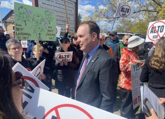 Federal transport minister Steven MacKinnon wades into a crowd of people protesting against the Alto high-speed rail project outside the office of the Peterborough and Kawarthas Chamber of Commerce after he arrived to speak at an event hosted by the Chamber on May 8, 2026. (Photo: Paul Rellinger / kawarthaNOW)