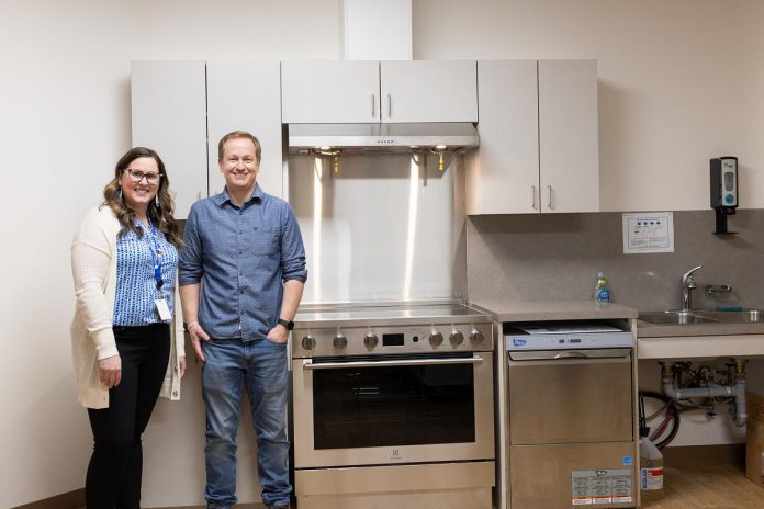 Peterborough Community Health Centre executive director Ashley Safar with Craig Mortlock, co-owner of MCI Constructors Inc., which donated $30,000 to the centre to fund the full outfitting of a new community kitchen and the purchase and installation of a washer and dryer. The new additions will allow the centre to address immediate needs of its clients from marginalized communities as well as improve the centre's ability to provide wraparound community-based care. (Photo courtesy of Peterborough Community Health Centre)