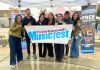 The Peterborough Musicfest team, led by executive director Tracey Randall (middle), celebrating the lineup of free-admission summer outdoor concerts for the festival's 39th season during an announcement event at Quaker Foods City Square in downtown Peterborough on May 13, 2026. (Photo: Paul Rellinger / kawarthaNOW)