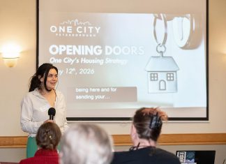 Tammy Kuehne, acting executive director of One City Peterborough, speaks to attendees at an event to discuss the non-profit organization's housing strategy at Knights of Columbus Hall on May 12, 2026. (Photo: Jordan Lyall / kawarthaNOW)