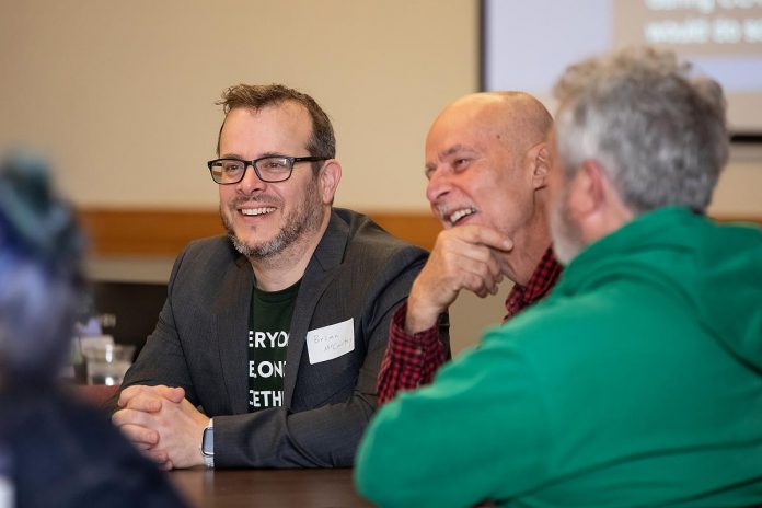 Brian McCarthy (left), finance and operations manager at One City Peterborough, during an event to discuss the non-profit organization's housing strategy at Knights of Columbus Hall on May 12, 2026. (Photo: Jordan Lyall / kawarthaNO