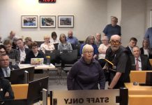 An irate member of the public shouts at councillors during a debate on a winter shelter response plan for homelessness at city council's general committee meeting on May 25, 2026. (kawarthaNOW screenshot of City of Peterborough video)