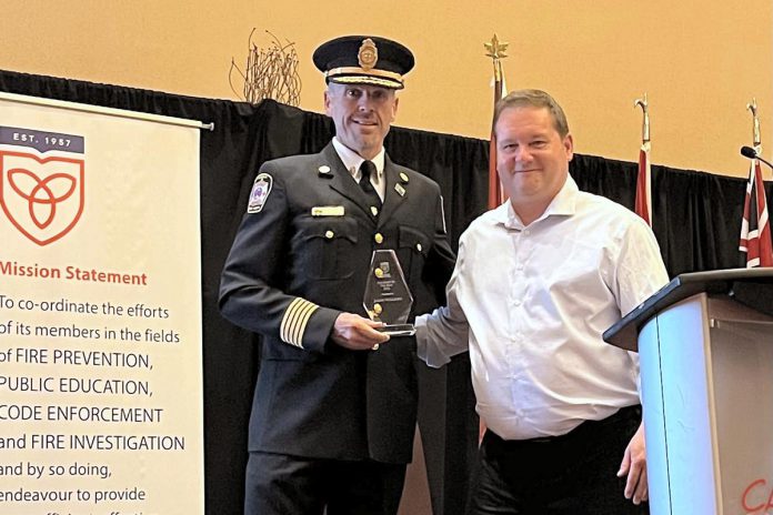 Port Hope fire chief Jason Williams receiving the 2026 Fire Chief of the Year award from Ontario Municipal Fire Prevention Officers Association vice-president Don Casey on May 27, 2026 at the association's 69th annual symposium training and education symposium at Casino Rama in Orillia. (Photo via Municipality of Port Hope)