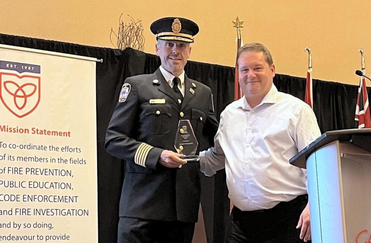 Port Hope’s Jason Williams named 2026 Fire Chief of the Year Port Hope fire chief Jason Williams receiving the 2026 Fire Chief of the Year award from Ontario Municipal Fire Prevention Officers Association vice-president Don Casey on May 27, 2026 at the association's 69th annual symposium training and education symposium at Casino Rama in Orillia. (Photo via Municipality of Port Hope)