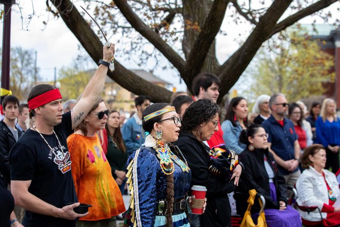 Residents of Nogojiwanong-Peterborough gathered at Peterborough City Hall on May 5, 2026 to commemorate Red Dress Day at an event led by the Urban Indigenous Working Group in collaboration with the City of Peterborough. May 5 has been recognized as the National Day of Awareness for Missing and Murdered Indigenous Women, Girls, and 2SLGBTQI+ People (MMIWG2S+) since 2010. (Photo: Jordan Lyall / kawarthaNOW)