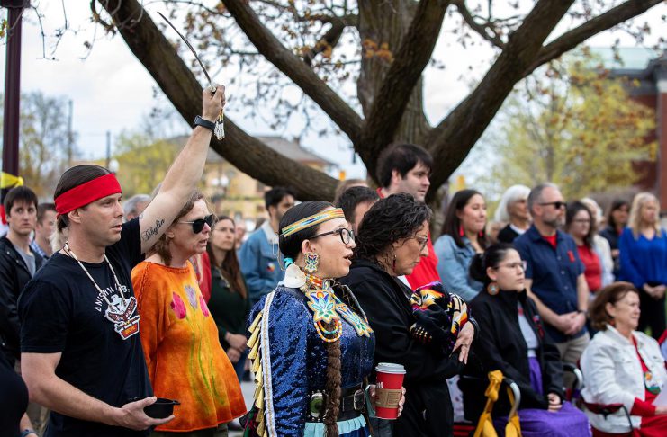 Residents of Nogojiwanong-Peterborough gathered at Peterborough City Hall on May 5, 2026 to commemorate Red Dress Day at an event led by the Urban Indigenous Working Group in collaboration with the City of Peterborough. May 5 has been recognized as the National Day of Awareness for Missing and Murdered Indigenous Women, Girls, and 2SLGBTQI+ People (MMIWG2S+) since 2010. (Photo: Jordan Lyall / kawarthaNOW)