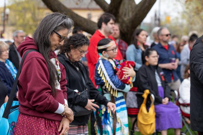Attendees at an event to commemorate Red Dress Day at Peterborough City Hall on May 5, 2026. (Photo: Jordan Lyall / kawarthaNOW)