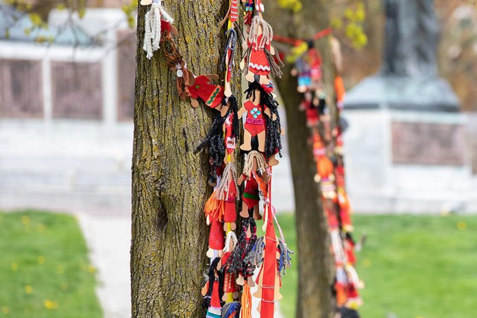 Faceless dolls representing missing and murdered Indigenous women at an event to commemorate Red Dress Day at Peterborough City Hall on May 5, 2026. Ahead of the gathering, the Urban Indigenous Working Group and Lovesick Lake Native Women's Association hosted two workshops where community members participated in crafting felt faceless dolls and collecting red dresses. (Photo: Jordan Lyall / kawarthaNOW)