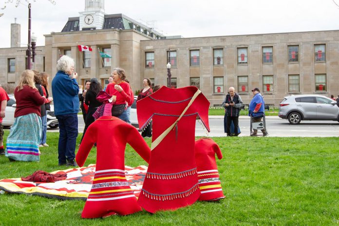 Red dresses representing missing and murdered Indigenous women at an event to commemorate Red Dress Day at Peterborough City Hall on May 5, 2026. (Photo: Jordan Lyall / kawarthaNOW)