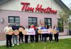 Representatives from Five Counties Children's Centre and the Peterborough Humane Society each hold a cheque for $68,355.98, representing their share of the $138,711.96 raised at 18 Tim Hortons locations across Peterborough, Bridgenorth, Lakefield, and Curve Lake which donated 100 per cent of the proceeds of the sale of Smile Cookies between April 27 and May 3, 2026. (Photo courtesy of Five Counties)