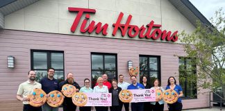 Representatives from Five Counties Children's Centre and the Peterborough Humane Society each hold a cheque for $68,355.98, representing their share of the $138,711.96 raised at 18 Tim Hortons locations across Peterborough, Bridgenorth, Lakefield, and Curve Lake which donated 100 per cent of the proceeds of the sale of Smile Cookies between April 27 and May 3, 2026. (Photo courtesy of Five Counties)