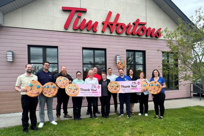 Representatives from Five Counties Children's Centre and the Peterborough Humane Society each hold a cheque for $68,355.98, representing their share of the $138,711.96 raised at 18 Tim Hortons locations across Peterborough, Bridgenorth, Lakefield, and Curve Lake which donated 100 per cent of the proceeds of the sale of Smile Cookies between April 27 and May 3, 2026. (Photo courtesy of Five Counties) Representatives from Five Counties Children's Centre and the Peterborough Humane Society each hold a cheque for $68,355.98, representing their share of the $138,711.96 raised at 18 Tim Hortons locations across Peterborough, Bridgenorth, Lakefield, and Curve Lake which donated 100 per cent of the proceeds of the sale of Smile Cookies between April 27 and May 3, 2026. (Photo courtesy of Five Counties)