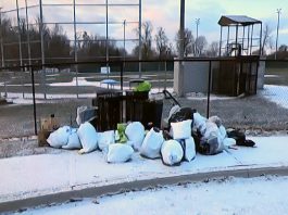 This photo of bags of garbage dumped at James Stevenson Park in Peterborough's East City was part of a city staff presentation on the Clean Streets Peterborough initiative to city council meeting as general committee on May 25, 2026. (kawarthaNOW screenshot of City of Peterborough video)