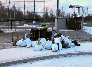 This photo of bags of garbage dumped at James Stevenson Park in Peterborough's East City was part of a city staff presentation on the Clean Streets Peterborough initiative to city council meeting as general committee on May 25, 2026. (kawarthaNOW screenshot of City of Peterborough video)
