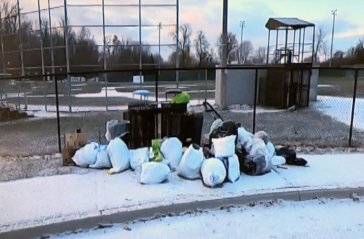 This photo of bags of garbage dumped at James Stevenson Park in Peterborough's East City was part of a city staff presentation on the Clean Streets Peterborough initiative to city council meeting as general committee on May 25, 2026. (kawarthaNOW screenshot of City of Peterborough video)