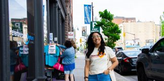 Peterborough Downtown Business Improvement Area revives original logo as it celebrates its 45th year Peterborough Downtown Business Improvement Area (DBIA) executive director Nour Mazloum walks downtown wearing a T-shirt with the original DBIA logo from when the organization was founded in 1981. The merchandise is being rolled out as part of a celebration for the organization's 45-year anniversary, just as Mazloum reflects on her two years at its helm. (Photo courtesy of Peterborough DBIA)