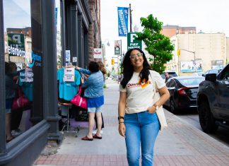 Peterborough Downtown Business Improvement Area revives original logo as it celebrates its 45th year Peterborough Downtown Business Improvement Area (DBIA) executive director Nour Mazloum walks downtown wearing a T-shirt with the original DBIA logo from when the organization was founded in 1981. The merchandise is being rolled out as part of a celebration for the organization's 45-year anniversary, just as Mazloum reflects on her two years at its helm. (Photo courtesy of Peterborough DBIA)