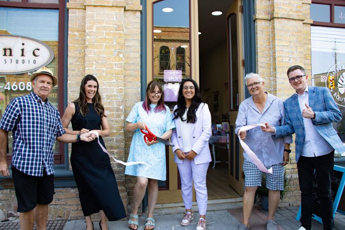 Whimsy and Wonder is one of several new businesses that have opened in downtown Peterborough over the past two years. Participating in the July 2025 ribbon-cutting ceremony for a art boutique and gift shop are (left to right) Peterborough city councillor Kevin Duguay, Peterborough MP Emma Harrison, Whimsy and Wonder owner Susan Armstrong, Peterborough Downtown Business Improvement Area (DBIA) executive director Nour Mazloum, councillor Joy Lachica, and City of Peterborough economic development director Darryl Jullot. (Photo courtesy of Peterborough DBIA)