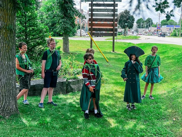 Participants of Globus Theatre's School of Dramatic Arts (SODA) summer camp in 2024 presenting the Downtown Detective Trail to add to the mainstage murder mystery show "Who Killed the King." For the 2026 season, the Downtown Detective Trail will be held as a bus tour from July 27 to 31 as a part of Bobcaygeon's 150-year anniversary celebrations. (Photo courtesy of Globus Theatre)