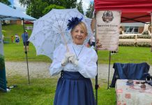 Hystory Entertainment founder Jacquie Barker at the Freshwater Summit Festival in Coboconk on June 20, 2026, promoting her debut Victorian murder mystery experience "Murder at Birchwood Estate" at the Coboconk Community Centre on July 10 and 11. The interactive event will feature a three-course meal, a silent auction, and an opportunity to learn about local history during the Victorian era. (Photo courtesy of Hystory Entertainment)