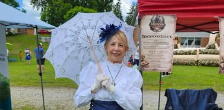 Hystory Entertainment founder Jacquie Barker at the Freshwater Summit Festival in Coboconk on June 20, 2026, promoting her debut Victorian murder mystery experience "Murder at Birchwood Estate" at the Coboconk Community Centre on July 10 and 11. The interactive event will feature a three-course meal, a silent auction, and an opportunity to learn about local history during the Victorian era. (Photo courtesy of Hystory Entertainment)