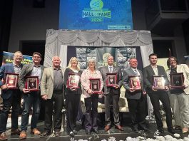 The nine Peterborough business leaders who were inducted into the 11th annual JA Business Hall of Fame at The Venue in downtown Peterborough on June 4, 2026. As the ceremony, Junior Achievement of Northern and Eastern Ontario (JA-NEO) also announced that the late late John McNutt, the longtime CEO and president of JA-NEO and executive director of the Council for Persons with Disabilities, along with his wife of 47 years, Sheryl Hopkins, would also be inducted into the JA Business Hall of Fame. (Photo courtesy of JA-NEO)