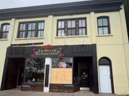Plywood covers a front window at La Mesita Restaurante at 247 George Street North in downtown Peterborough just north of Sherbrooke after it was vandalized around 2:35 a.m. on June 7, 2026. (Photo supplied to kawarthaNOW)
