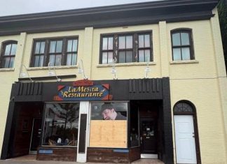Peterborough police defend response time after making arrest in La Mesita window smashing Plywood covers a front window at La Mesita Restaurante at 247 George Street North in downtown Peterborough just north of Sherbrooke after it was vandalized around 2:35 a.m. on June 7, 2026. (Photo supplied to kawarthaNOW)