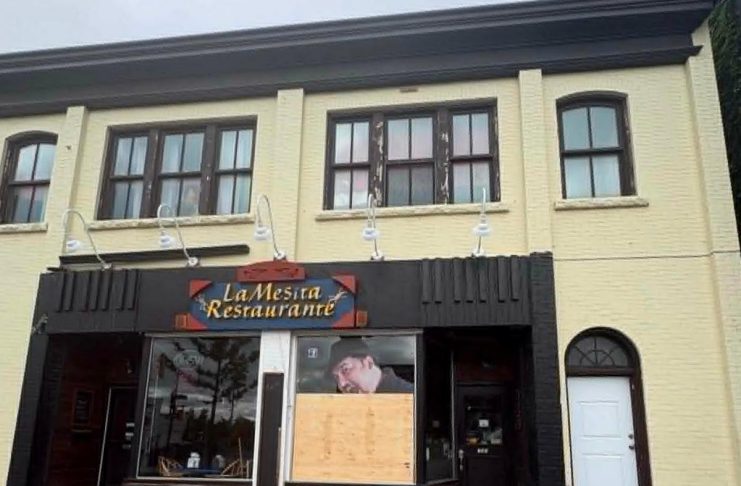 Peterborough police defend response time after making arrest in La Mesita window smashing Plywood covers a front window at La Mesita Restaurante at 247 George Street North in downtown Peterborough just north of Sherbrooke after it was vandalized around 2:35 a.m. on June 7, 2026. (Photo supplied to kawarthaNOW)