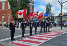 The Royal Canadian Legion Colour Party honouring the Veterans Memorial Crosswalk in downtown Lakefield during an official unveiling ceremony on June 20, 2026. Lakefield Legion Branch 77, Peterborough County, and Selwyn Township collaborated on the creation of the crosswalk, which also commemorates the 100th anniversary of the Lakefield Legion, one of the earliest chartered branches. (Photo: Selwyn Township)