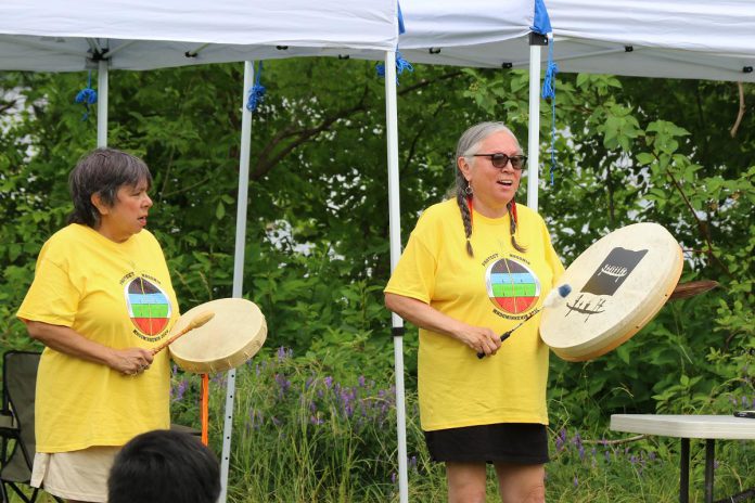 The New Canadians Centre's sixth annual "Lessons from the Land" event on July 1, 2026 will begin a community drumming circle led by Janet McCue (right) and her sister Linda of Curve Lake First Nation. (Photo courtesy of New Canadians Centre)