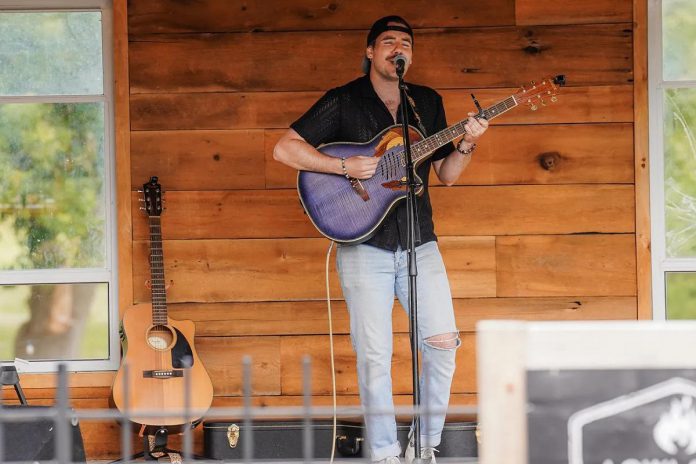 Ottawa-based musician Pat Rees performing at the "Songs for a Stronger Tomorrow" benefit concert for Canadian Mental Health Association Haliburton, Kawartha, Pine Ridge at 100 Acre Brewing Co. in 2025. The Peterborough native, who is working on his first full-length community, first organized the fundraiser because of his past struggles with mental health and addiction and his desire to give back to his hometown. (Photo courtesy of Pat Rees)