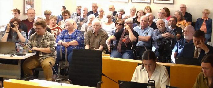 The public gallery at Peterborough city council chambers on June 1, 2026 included Northcrest Ward residents who opposed a temporary shelter being located at the former fire hall at 161 Carnegie Avenue. (kawarthaNOW screenshot of City of Peterborough video)